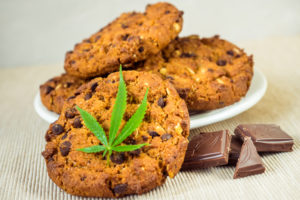 Delicious homemade Cookies with CBD cannabis and leaf garnish an