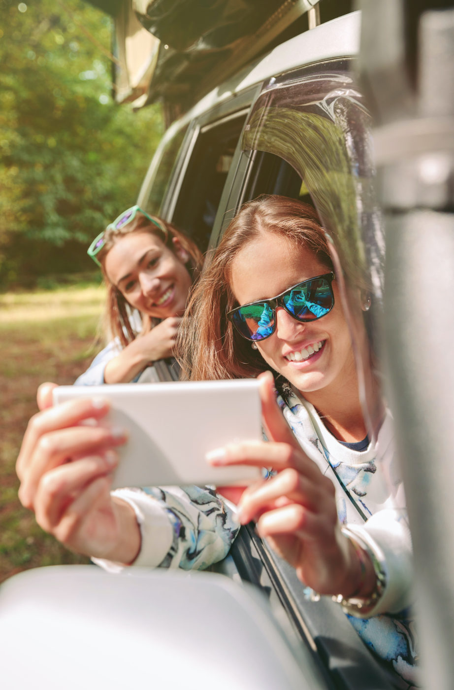 woman takes photo in car