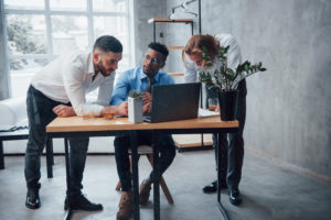 Multiracial business people with laptop solving the company issues