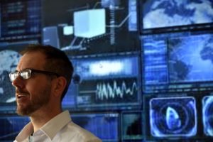 professional-male-speaking-in-front-of-a-digital-screen-in-technology-field-rltheis_t20_bkdadk