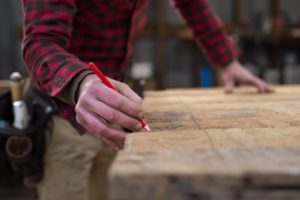detail-of-mans-hands-marking-a-piece-of-wood_t20_jX8GlN