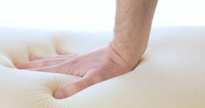 hand-is-pressing-a-memory-foam-mattress-2021-08-30-23-51-16-utc