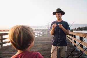 father-and-son-on-pier-preparing-fishing-rods-gol-2022-03-04-01-52-41-utc