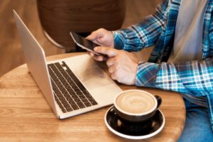 man-freelancer-working-online-with-macbook-and-mob-2022-11-15-21-40-22-utc