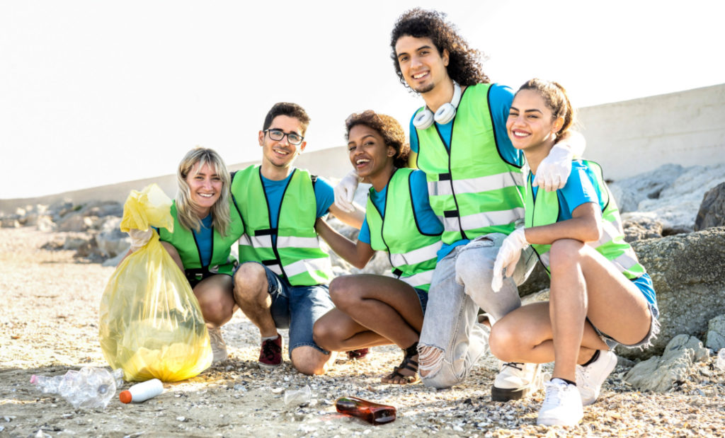 People group photo of young volunteers team wearing uniform at b