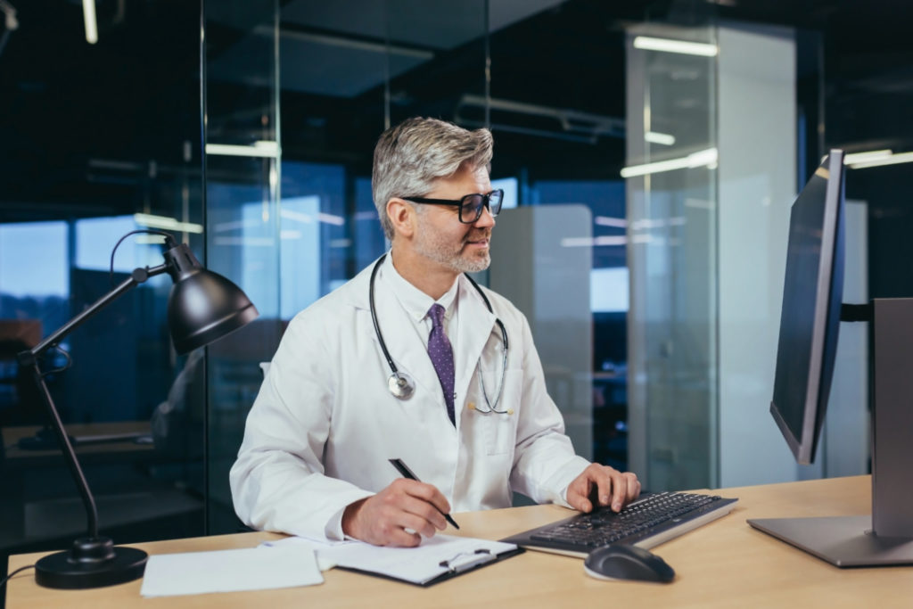 An experienced doctor works remotely, advises patients on a video call