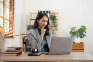 Asian business lawyer woman working with computer laptop in legal office.Law and Legal services concept.