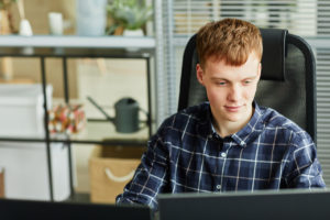 Young IT specialist working at his workplace